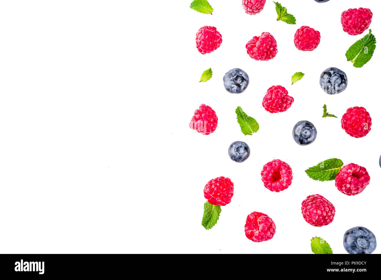 Creative layout with raspberry and blueberry with waffle ice cream cones, simple pattern above copy space Stock Photo