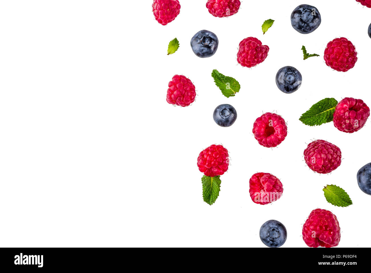 Creative layout with raspberry and blueberry with waffle ice cream cones, simple pattern above copy space Stock Photo