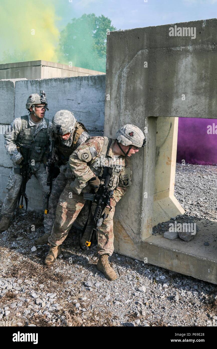 Officers with 1st Brigade Combat Team, 101st Airborne Division (Air Assault), stack against an outer wall before breaching the village during a raid training exercise at Range 65, Fort Campbell, Ky. May 23, 2016. The raid was part of the commander’s agility training, a two-day event meant to build esprit de corps throughout the company commanders within “Bastogne” and provide the brigade commander an opportunity to mentor his leaders on being adaptive and agile. (U.S. Army photo by Sgt. Samantha Stoffregen, 1st Brigade Combat Team, 101st Airborne Division (Air Assault) Public Affairs) Stock Photo