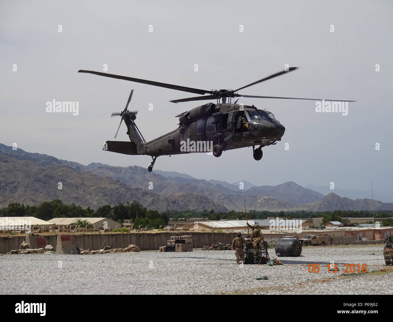 A UH-60 Black Hawk helicopter sling loads equipment from Forward Operating Base Joyce, Afghanistan, May 13, 2016. The 40th CAB sent a team of Washington and California Army National Guard fuelers to eastern Afghanistan to support the Afghan aviation mission. (Photo courtesy of Spc. Jeremy Miller) Stock Photo