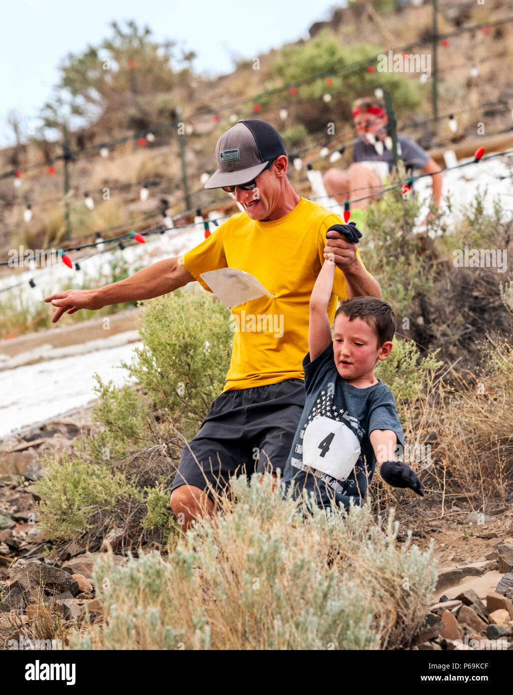 Father & young son compete in a foot race and climb up 'S' Mountain (Tenderfoot Mountain) during the annual Fibark Festival; Salida; Colorado; USA Stock Photo