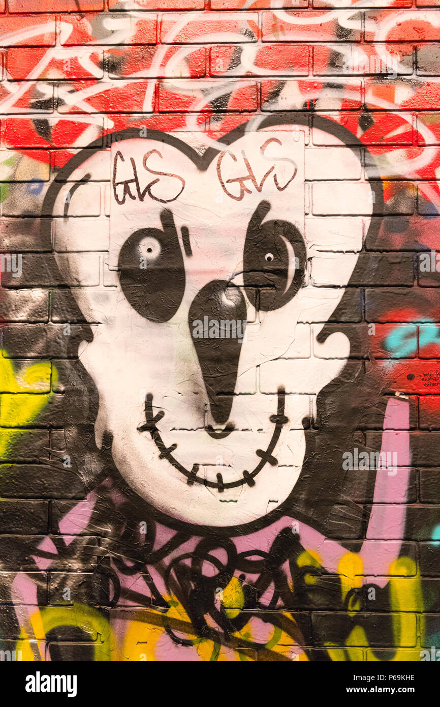 London Waterloo Leake Street graffiti detail cartoon face black white yellow long nose mouth sewed up Stock Photo