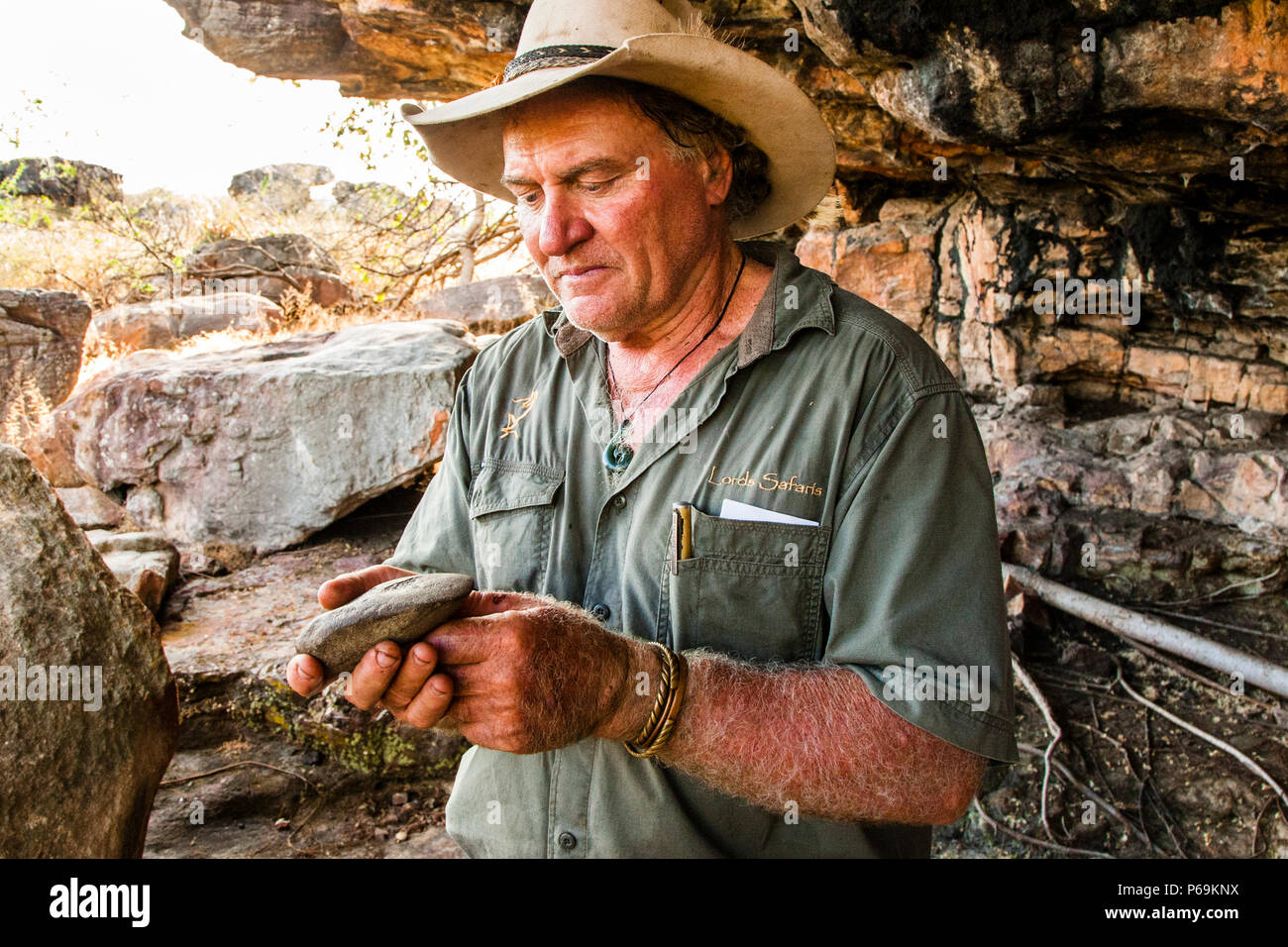 Ergonomically shaped hand wedge. Fortunately, the Stone Age tool is back at its original place of discovery. An American tourist had stolen it a few years ago and caused great mischief. In faraway Tasmania, the thief was caught shortly afterwards by Sab, who had remembered his travel plans. Aboriginal Rock Painting Safari with Sab Lord. Stock Photo