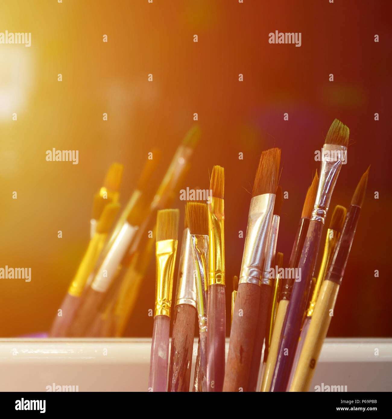 Art paint brushes in cup are located in the children's entertainment