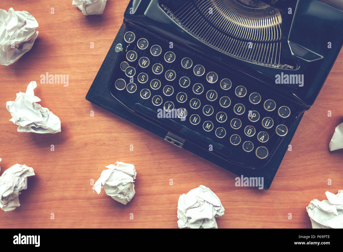 Writer's block concept with typewriter and crumpled paper on work desk Stock Photo