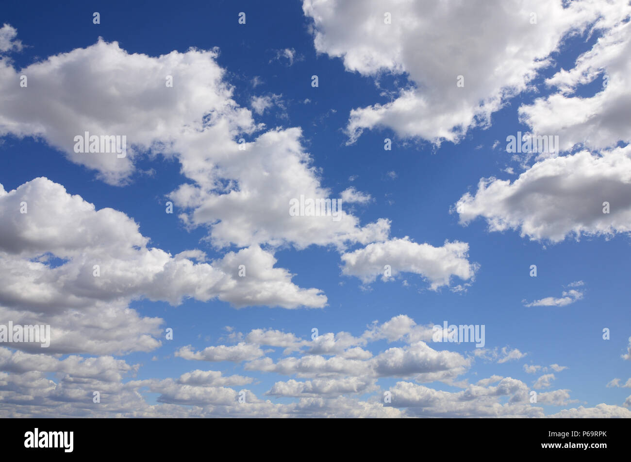 A blue sky with lots of white clouds of different sizes Stock Photo - Alamy