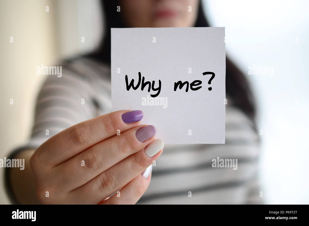 Young sad girl shows a white sticker. Caucasian brunette holding a ...