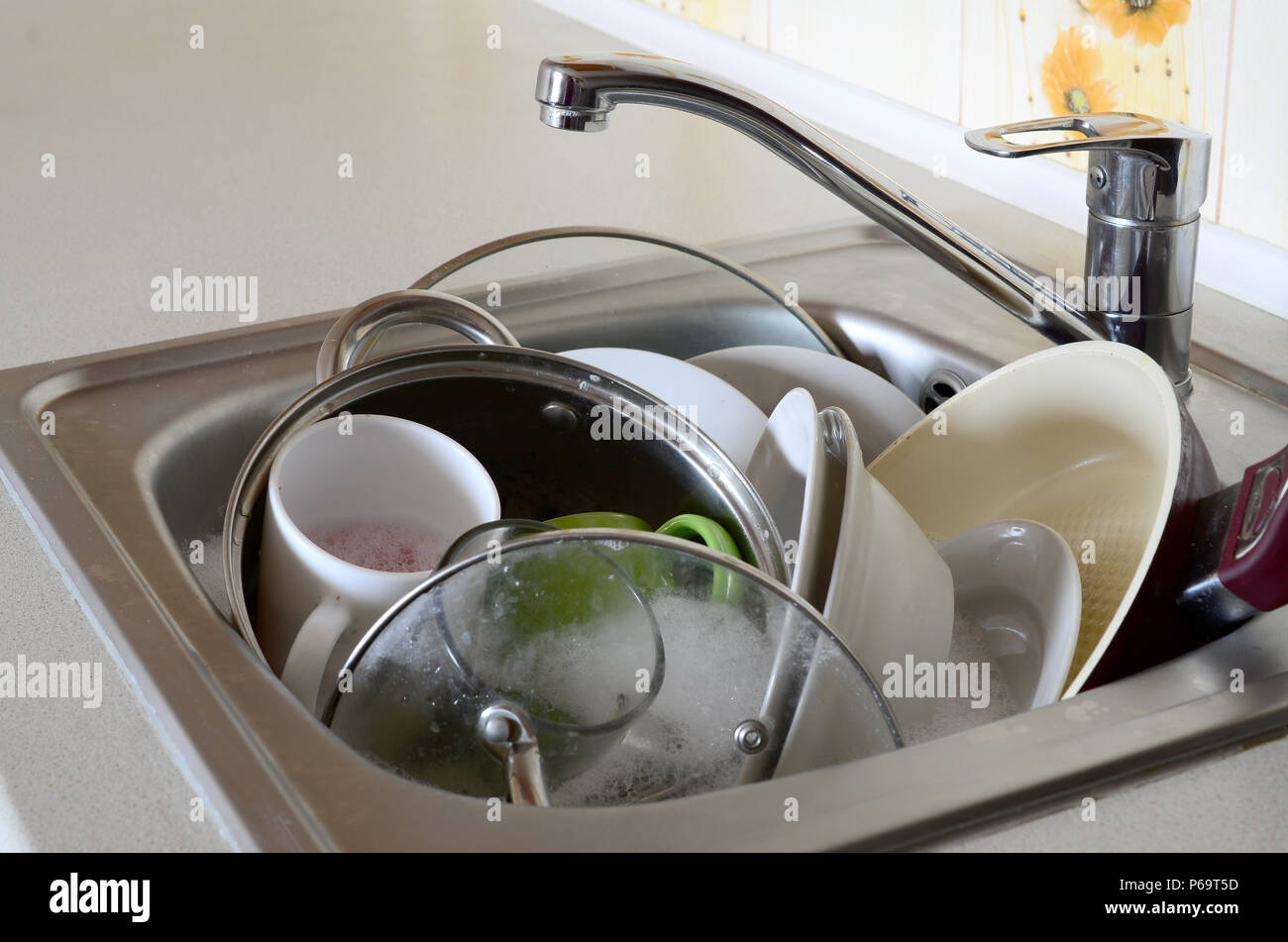 Dirty dishes and unwashed kitchen appliances filled the kitchen sink