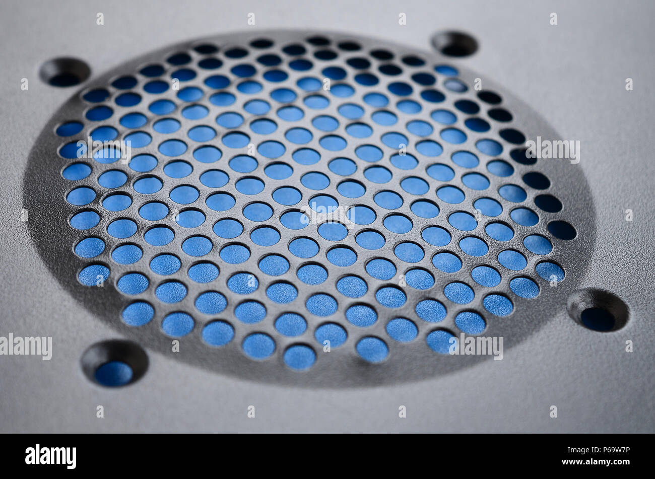 Close-up, shallow focus of a meshed style cooling panel used on a main frame computer. The circular holes aid active venting of hot air within the com Stock Photo