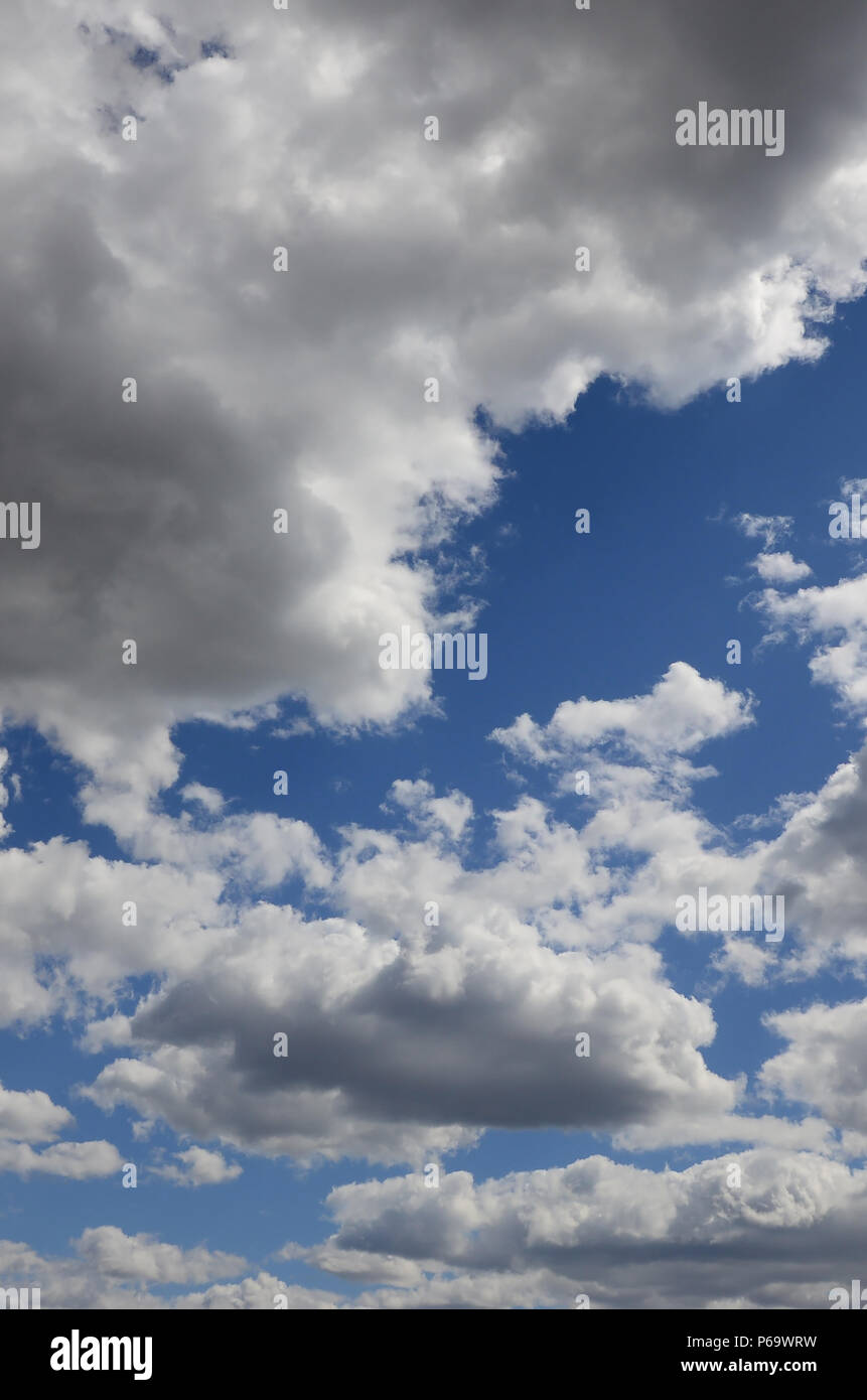 A blue sky with lots of white clouds of different sizes Stock Photo - Alamy
