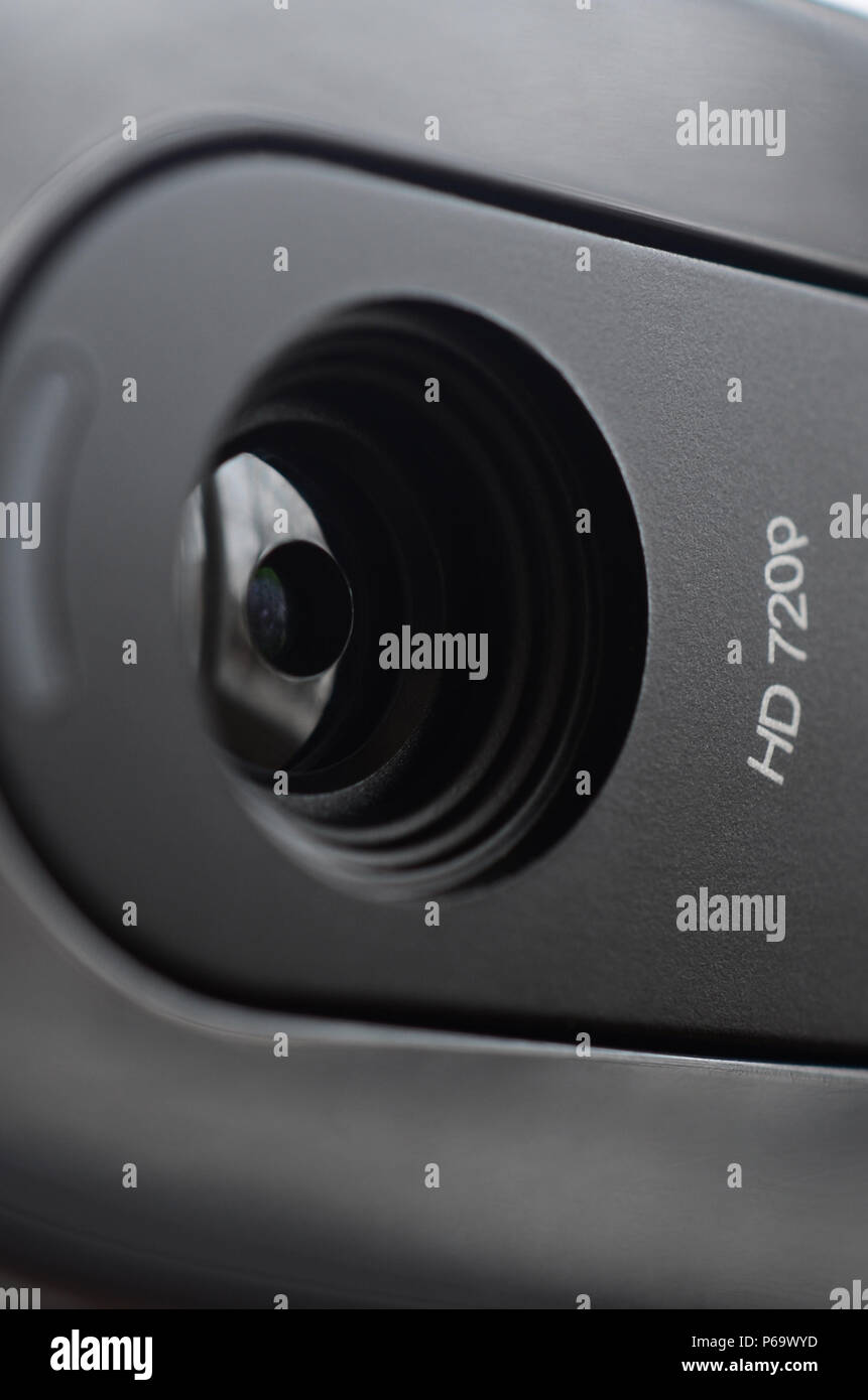 A modern web camera is installed on the body of a flat screen monitor ...