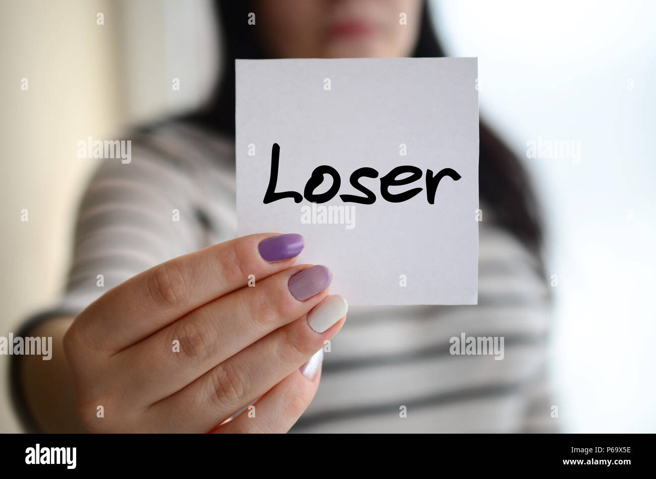 Young sad girl shows a white sticker. Caucasian brunette holding a ...