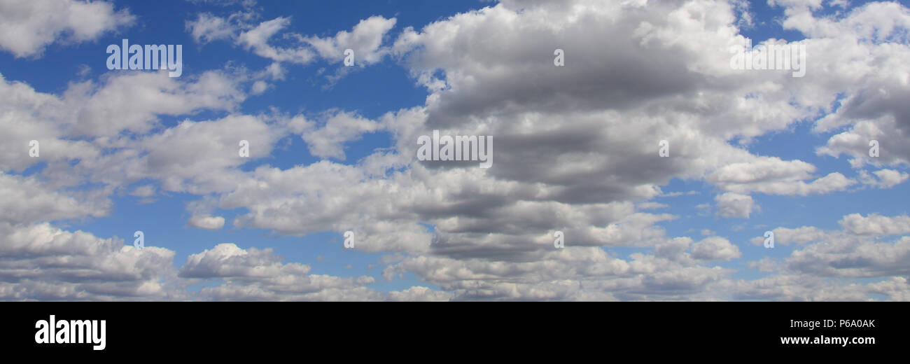 A blue sky with lots of white clouds of different sizes Stock Photo - Alamy
