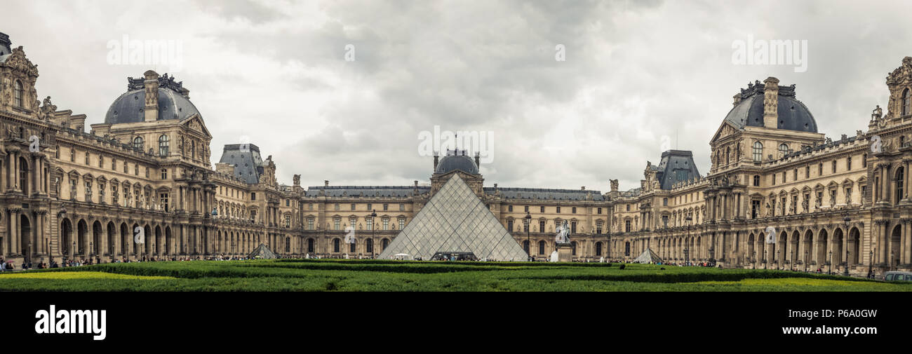 Louvre panorama of the museum and the glass Louvre Pyramid (Pyramide du Louvre) in the center. Stock Photo