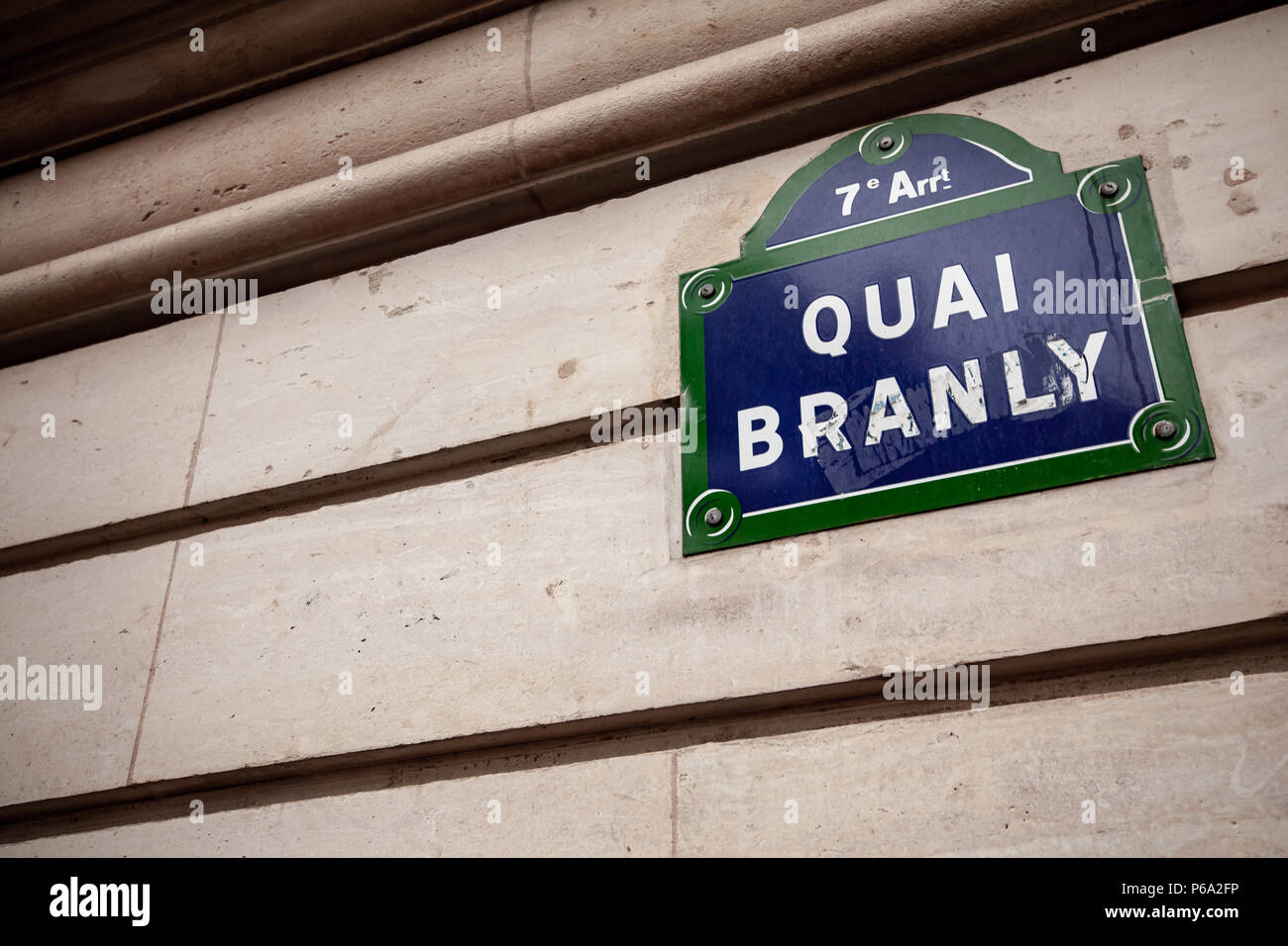 Paris, France - November 4, 2016: Quai Branly traditional blue Parisian nameplate mounted on old house  wall Stock Photo