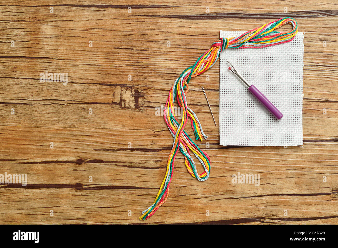 String of colorful embroidery thread displayed with a piece of ...