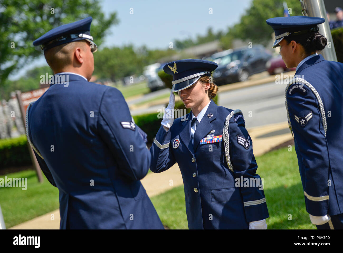 Senior Airman Tiffany Fogel, 99th Airlift Squadron administrative assistant and resource advisor, salutes after handing off an American flag during a Memorial Day retreat ceremony at the 89th Airlift Wing headquarters building at Joint Base Andrews, Md., May 26, 2016. In addition to her duties within the 99th AS, Fogel is serving on the JBA Honor Guard, and performs ceremonies such as this one; and is learning expertise in key areas such as manuals, uniforms, history and traditions and a variety of ceremonies. (U.S. Air Force photo by Senior Master Sgt. Kevin Wallace/RELEASED) Stock Photo