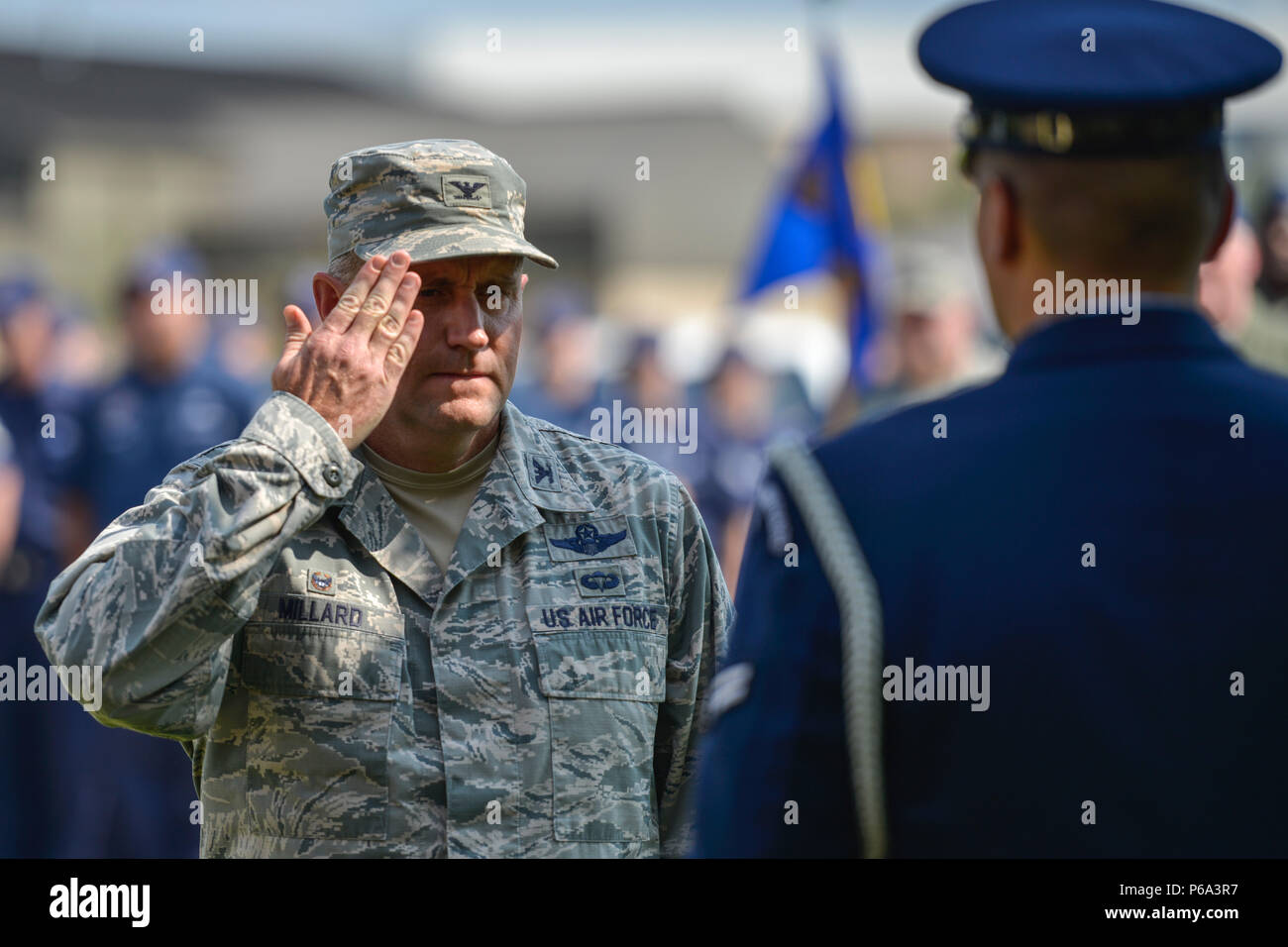 Col. J.C. Millard, 89th Airlift Wing commander, salutes an 11th Wing honor guard member and orders him to secure the American flag, during a Memorial Day retreat ceremony at the 89th AW headquarters building at Joint Base Andrews, Md., May 26, 2016. Memorial Day is an American federal holiday to remember those who died while serving in the U.S. armed forces. (U.S. Air Force photo by Senior Master Sgt. Kevin Wallace/RELEASED) Stock Photo
