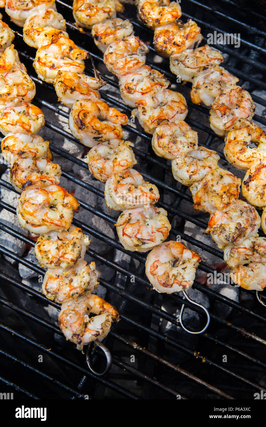 Shrimp skewered and cooking on a outdoor charcoal barbecue in southern