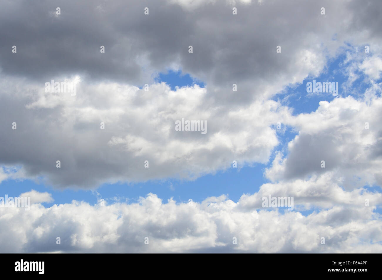 A blue sky with lots of white clouds of different sizes Stock Photo - Alamy