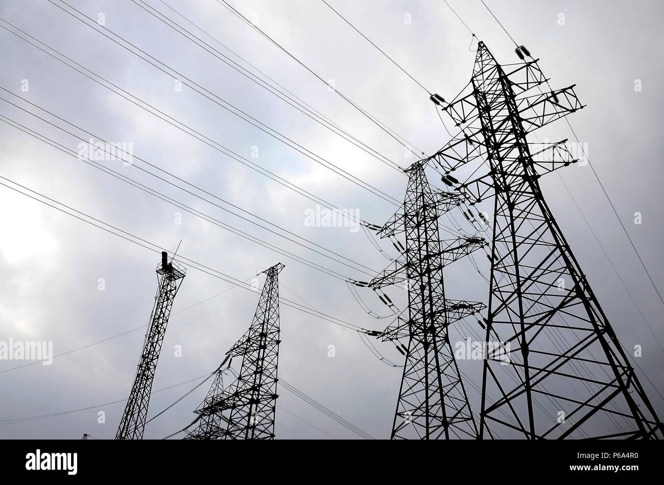 Towers power lines against a cloudy sky background. Electricity ...