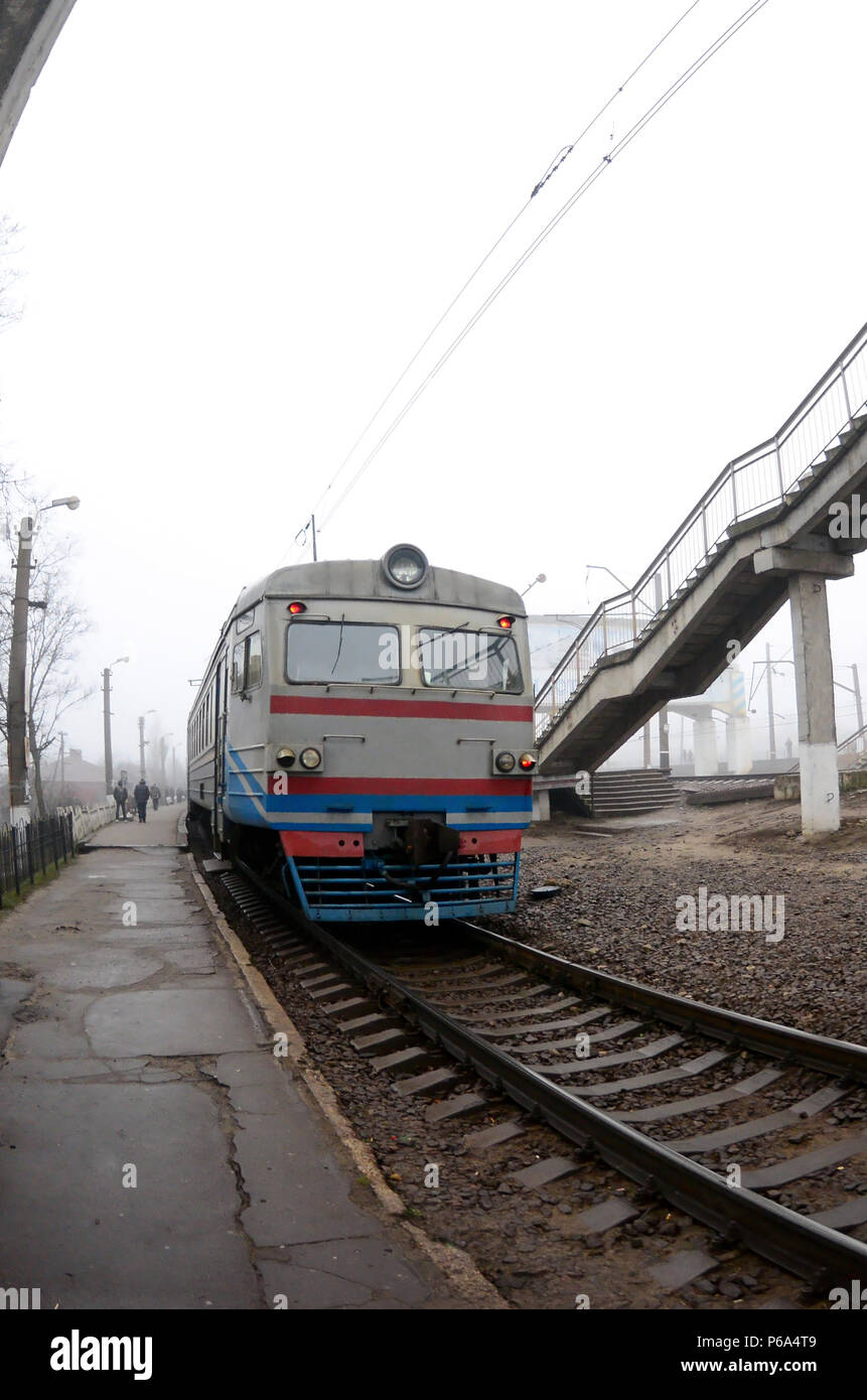 The railway track in a misty morning. The Ukrainian suburban train is ...