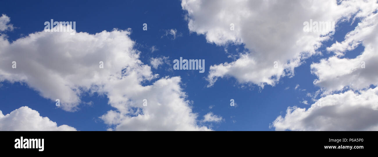 A blue sky with lots of white clouds of different sizes Stock Photo - Alamy