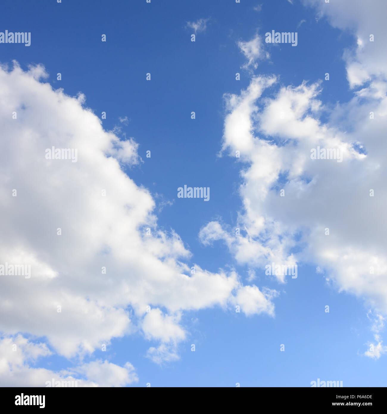 A blue sky with lots of white clouds of different sizes Stock Photo - Alamy