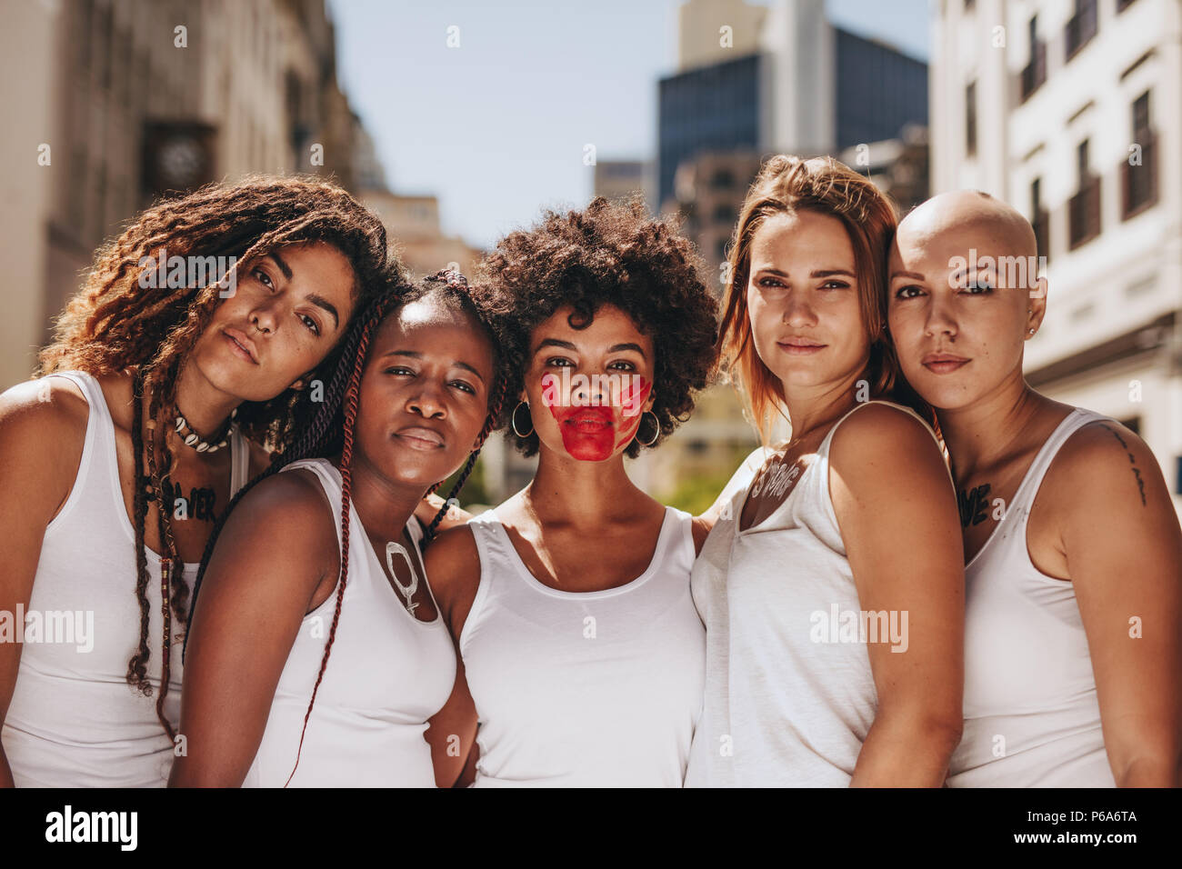 Group of women in dress code demonstrating outdoors for women rights. Demonstrating stop domestic violence and abuse on women and give respect. Stock Photo