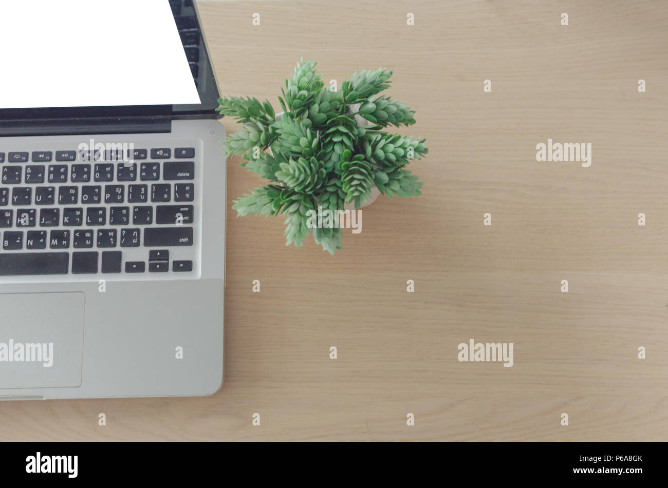 laptop blank screen on wooden table Stock Photo