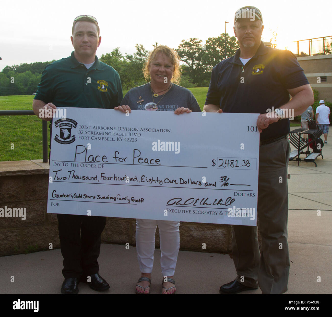 Sheila Patton, a Gold Star mother, receives a check for two thousand four hundred eighty one dollars and thirty eight cents to go towards her vision of a “Place for Peace” from the 101st Airborne Division Association at Cole Park, Fort Campbell, Ky., May 23, 2016.  A Place for Peace will include a pavilion, play area and walking trail for all Gold Star families to use near the Survivor Outreach Service facility. Stock Photo