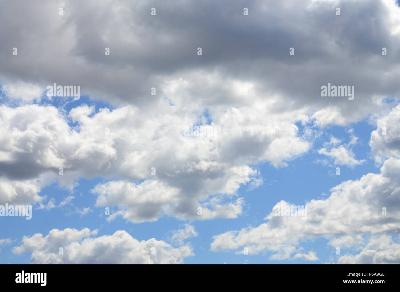 A blue sky with lots of white clouds of different sizes Stock Photo - Alamy