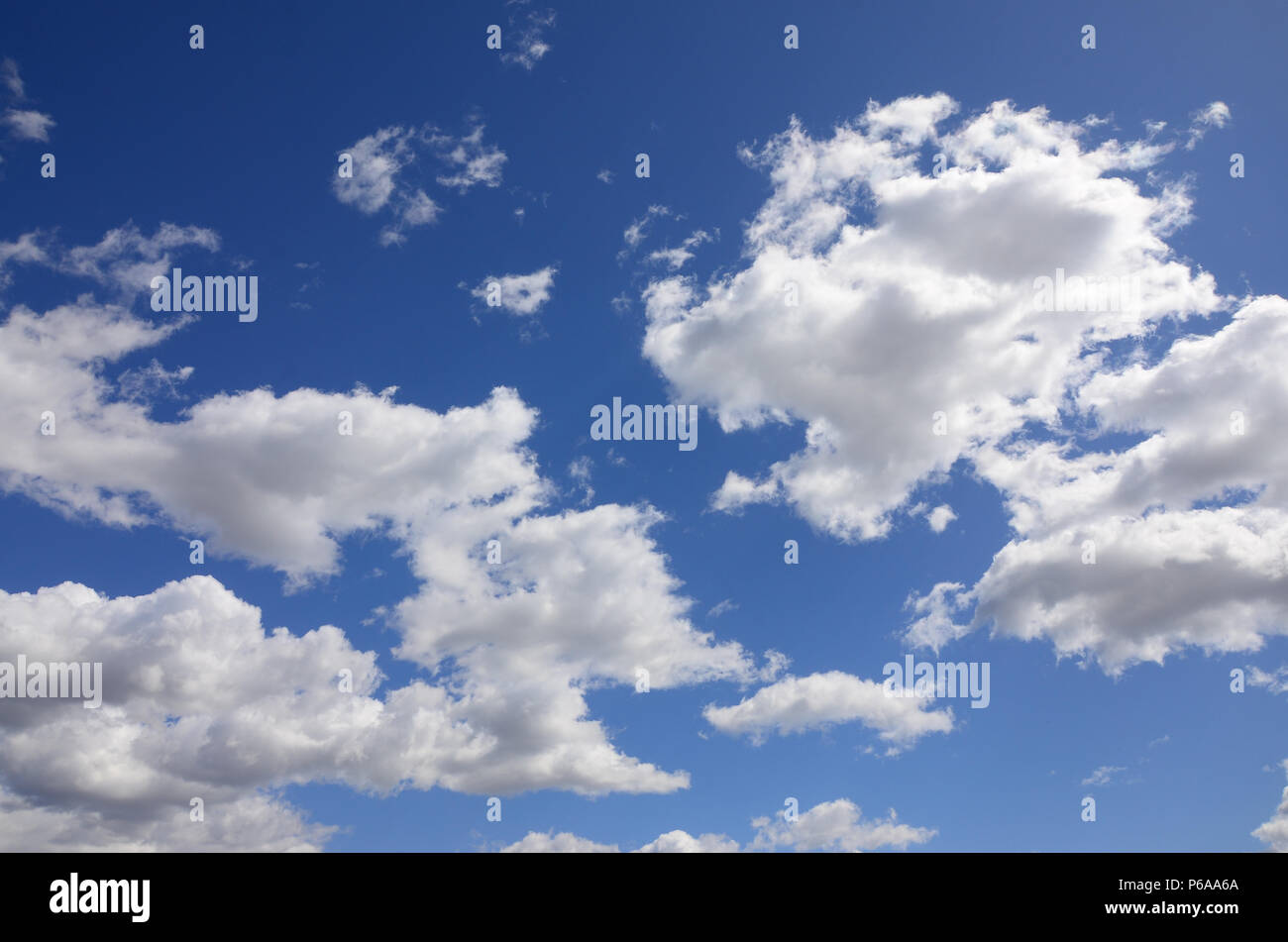 A blue sky with lots of white clouds of different sizes Stock Photo - Alamy