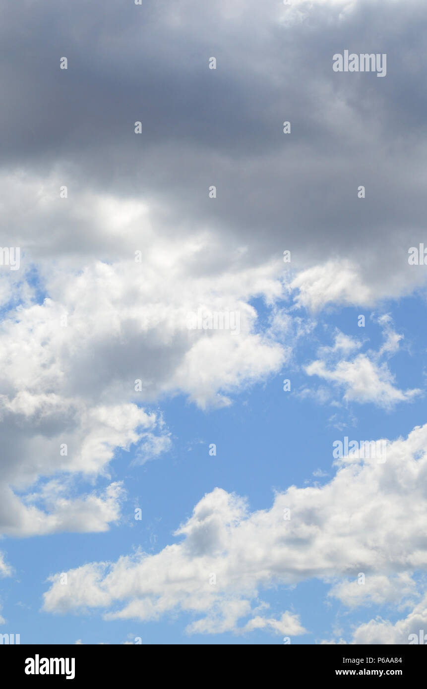 A blue sky with lots of white clouds of different sizes Stock Photo - Alamy