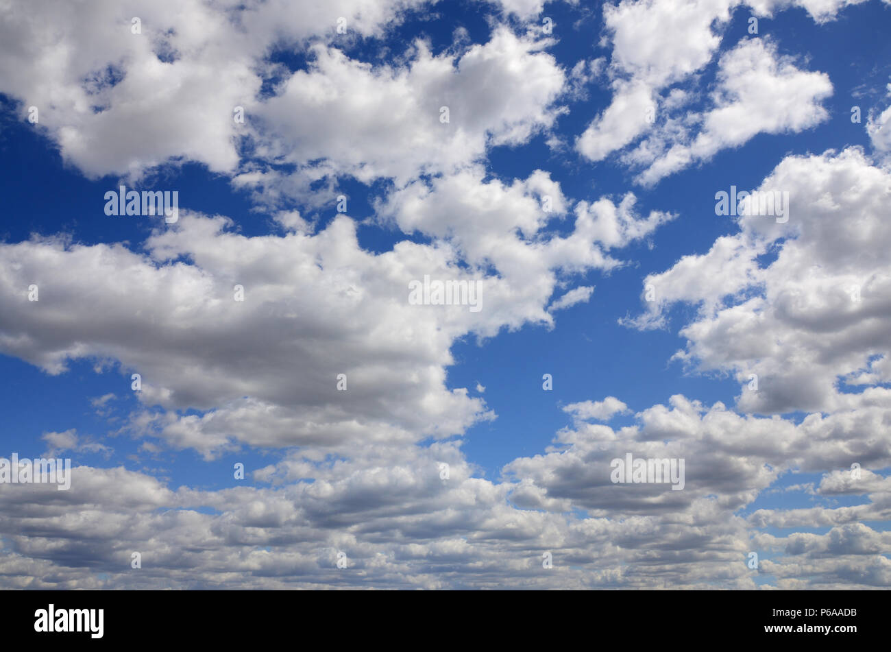 A blue sky with lots of white clouds of different sizes Stock Photo - Alamy