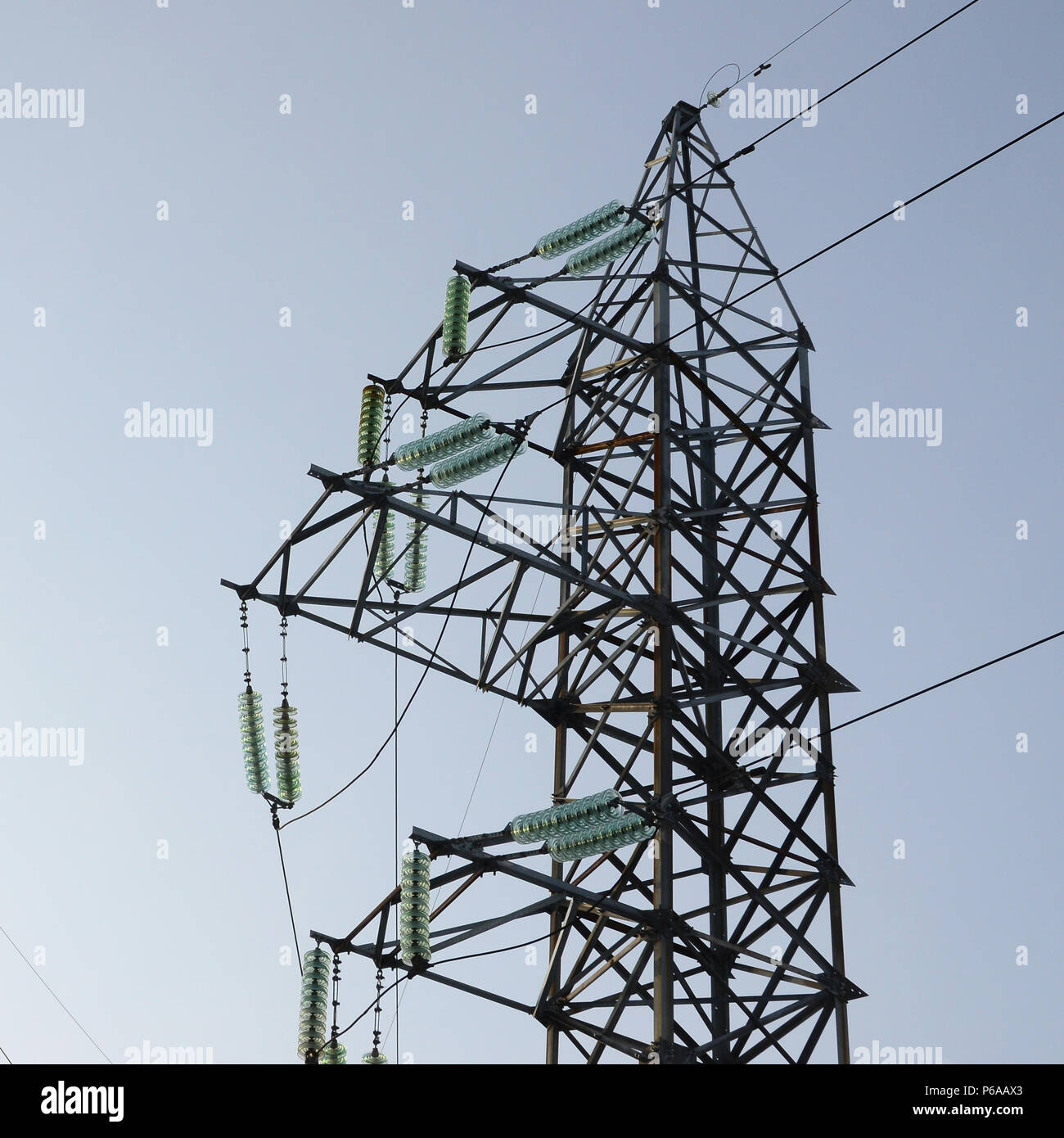 Power lines tower against the blue sky Stock Photo - Alamy