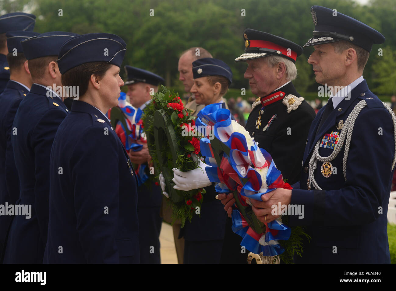 Sir Hugh Duberly, Her Majesty’s Lord-Lieutenant of Cambridgeshire and U.S. Air Force Brig Gen Dieter Bareihs, U.S. Senior Defense Attaché in London, accept their respective wreaths prior to placing them at the base of the Wall of the Missing on Memorial Day May 30, at Madingley American Cemetery in Cambridge, England. Hundreds gathered to honor the memory of the thousands of U.S. Soldiers, Sailors, Marines and Airmen who made the ultimate sacrifice in the service of their nation. (U.S. Air Force photo/ Tech Sgt. Matthew Plew) Stock Photo