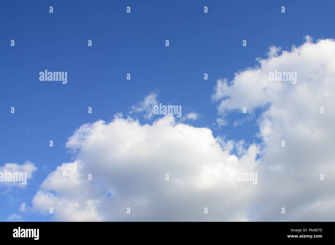 A blue sky with lots of white clouds of different sizes Stock Photo - Alamy