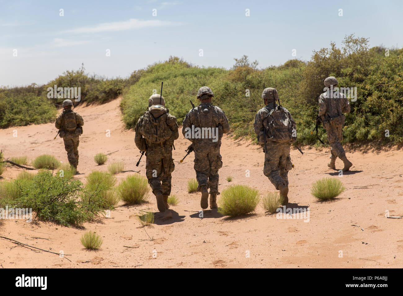 Soldiers assigned to Company C, 3rd Battalion, 41st Infantry Regiment, 1st Brigade Combat Team, 1st Armored Division, patrol the area during Hustler Trough III May 24 at the Orogrande Range Complex, N.M. Stock Photo