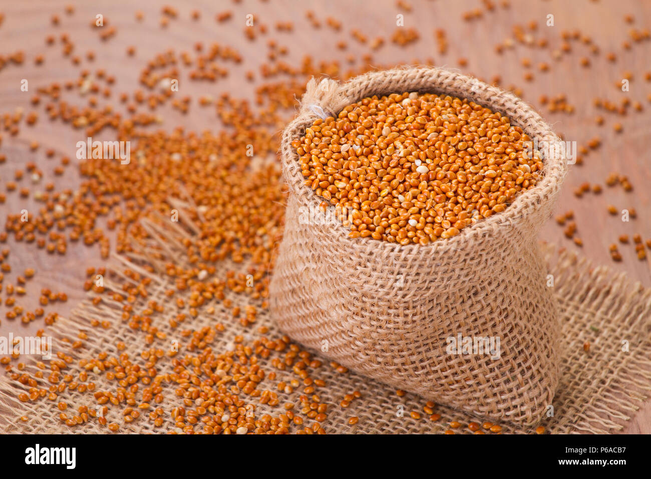 red millet seeds on wooden background, super food Stock Photo Alamy