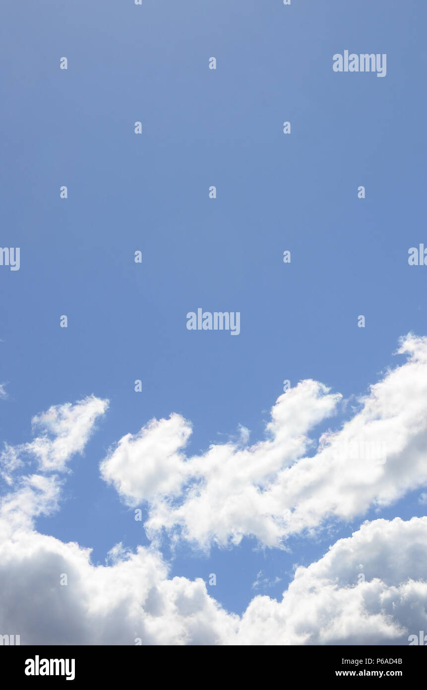 A blue sky with lots of white clouds of different sizes Stock Photo - Alamy