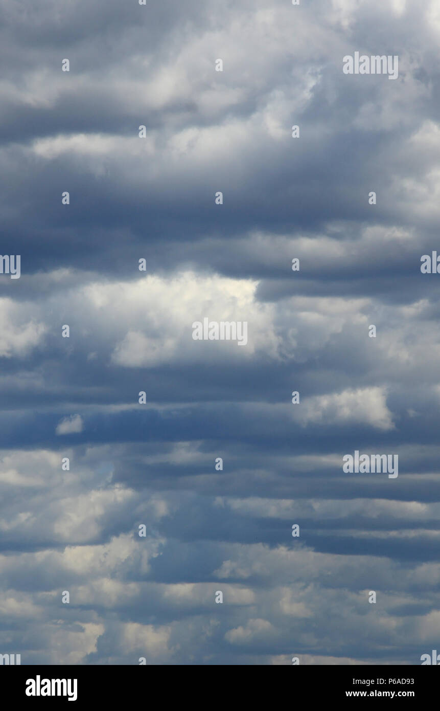 A blue sky with lots of white clouds of different sizes Stock Photo - Alamy