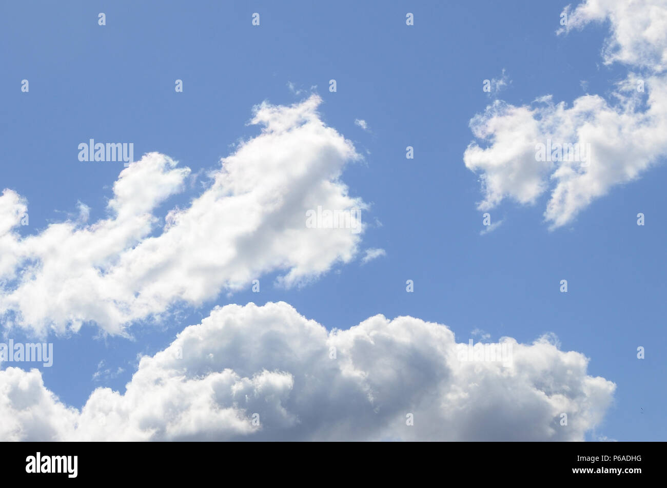 A blue sky with lots of white clouds of different sizes Stock Photo - Alamy