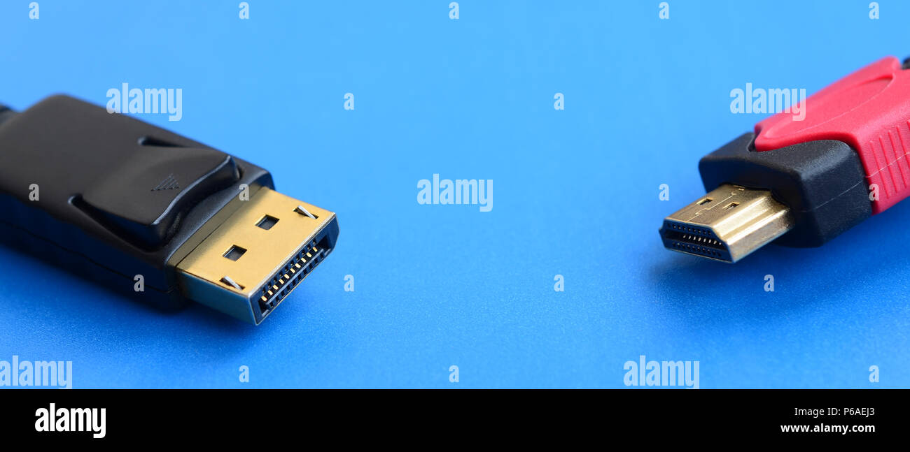 Audio video HDMI computer cable plug and 20-pin male DisplayPort gold plated connector for a flawless connection on a blue background . Stock Photo