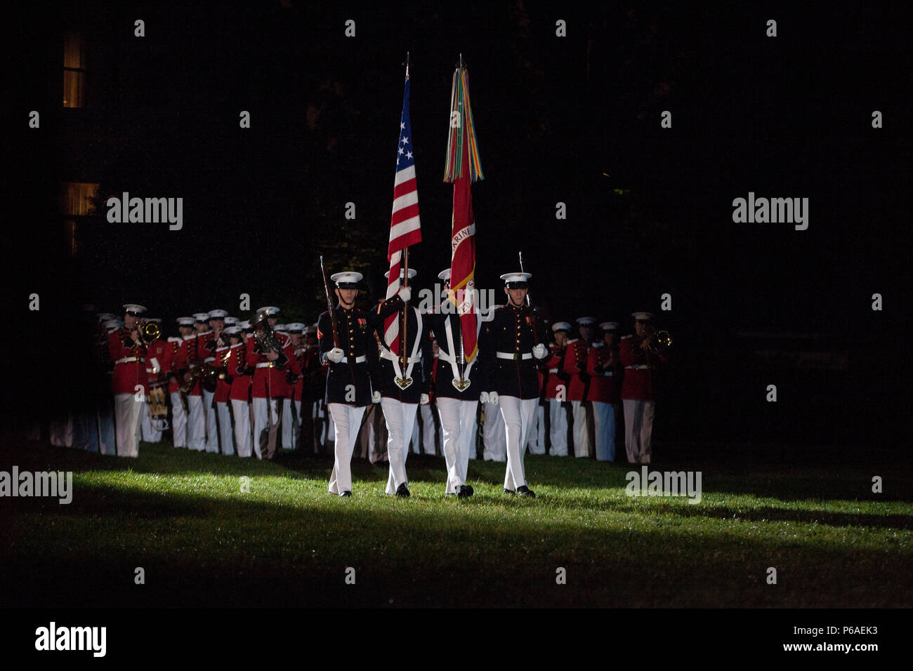 Members of the Marine Barracks Washington (MBW) Color Guard march the colors during an Evening Parade at MBW, Washington, D.C., April 29, 2016. The guest of honor was Gen. Robert B. Neller, the 37th commandant of the Marine Corps, and the hosting official was Col. Benjamin T. Watson, commanding officer, Marines Barracks Washington. The evening parade summer tradition began in 1934 and features the Silent Drill Platoon, the U.S. Marine Band, the U.S. Marine Drum and Bugle Corps and two marching companies. More than 3,500 guests attend the parade every week. (U.S. Marine Corps photo by Lance Cpl Stock Photo