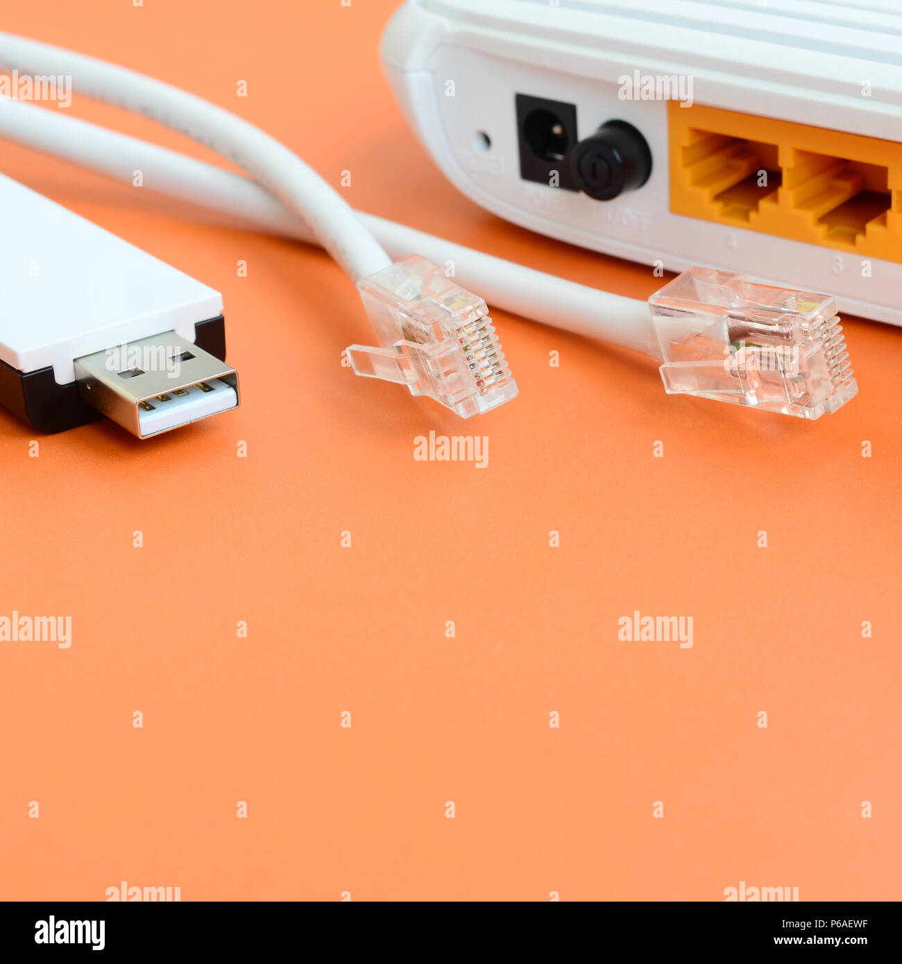 Internet router, portable USB wi-fi adapter and internet cable plugs lie on  a bright orange background. Items required for internet connection Stock  Photo - Alamy