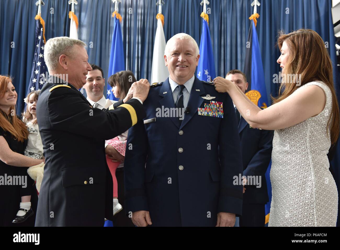 Air Force Lt. Gen. L. Scott Rice is pinned with his third star by his