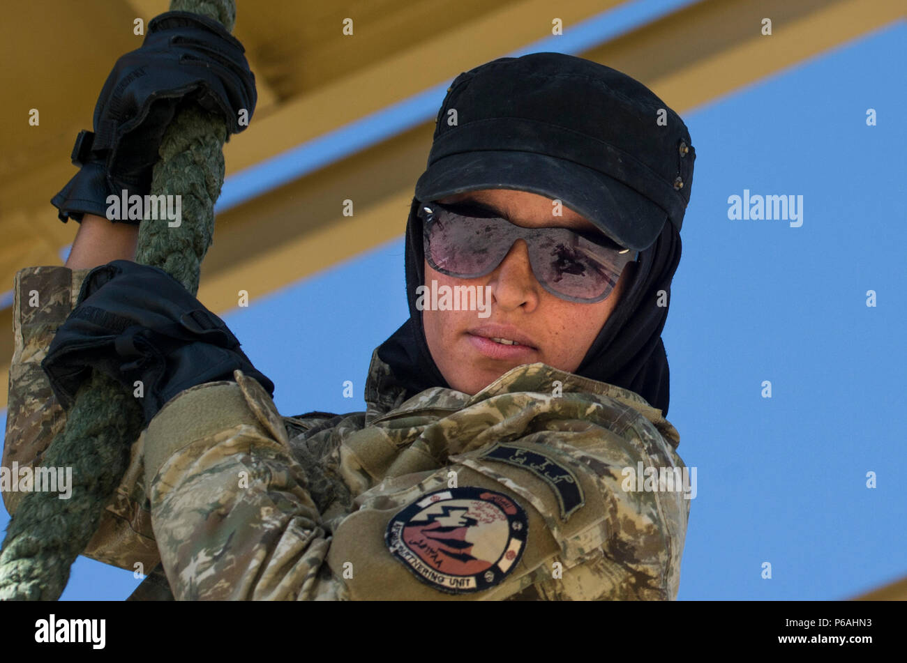 A Ktah Khas Afghan Female Tactical Platoon member participates in a fast roping training drill outside Kabul, Afghanistan May 29, 2016. The females work closely alongside the males on operations to engage and interact with women and children. The FTPs are trained in marksmanship, language, fast roping and other combat-related skills. (U.S. Air Force photo by Staff Sgt. Douglas Ellis/Released) Stock Photo