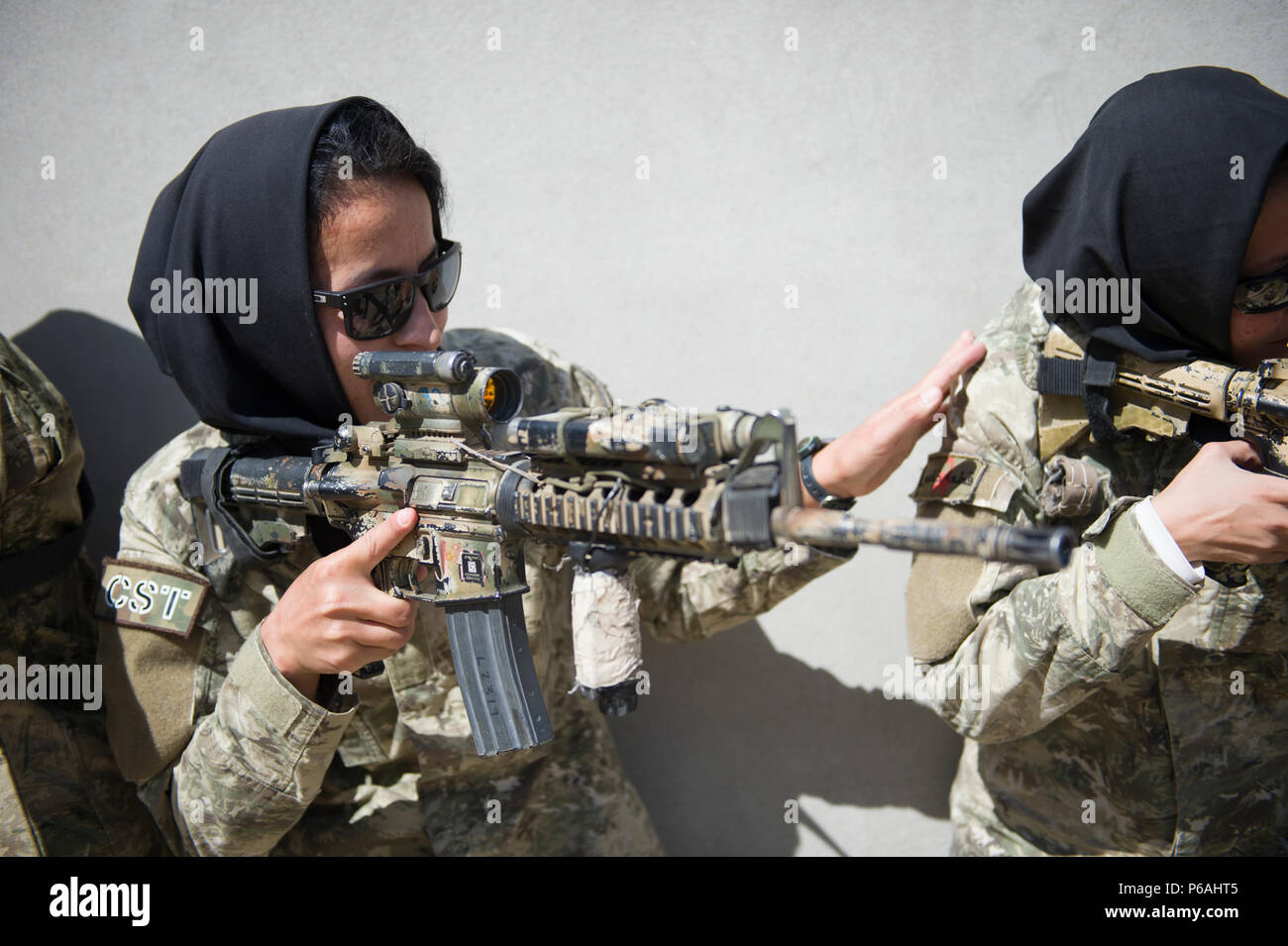 Ktah Khas Afghan Female Tactical Platoon members perform a close quarters battle drill drill outside Kabul, Afghanistan May 29, 2016. The females work closely alongside the males on operations to engage and interact with women and children. The FTPs are trained in marksmanship, language, fast roping and other combat-related skills. (U.S. Air Force photo by Staff Sgt. Douglas Ellis/Released) Stock Photo