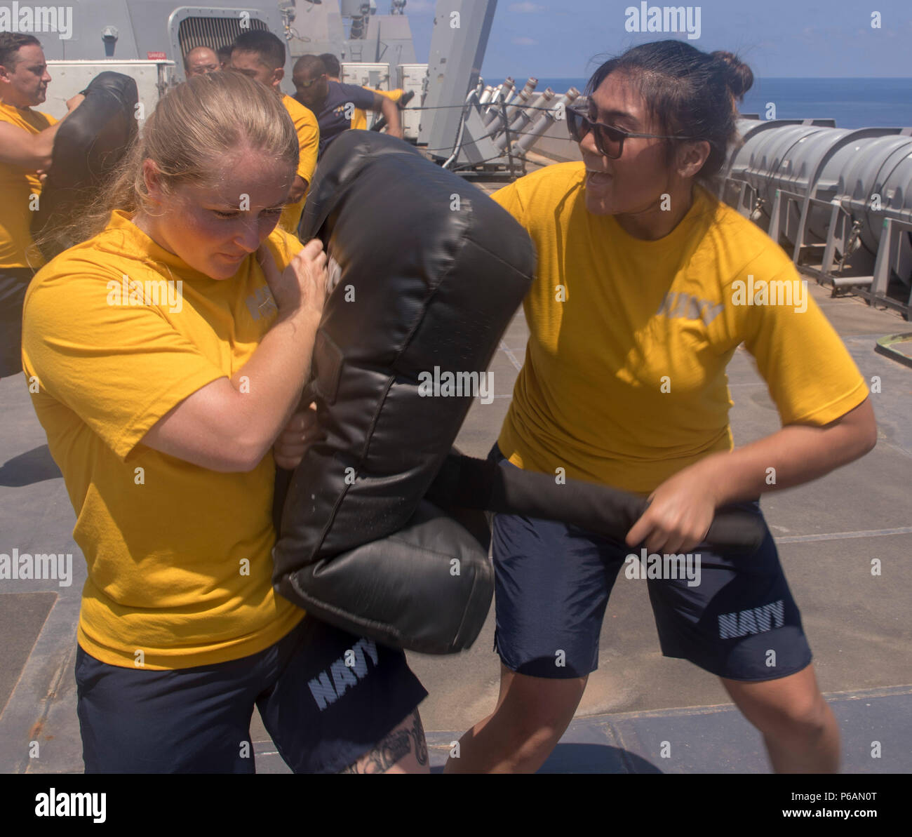 180621-N-GR168-0116 MEDITERRANEAN SEA (June 21, 2018) Ensign Genelle Arandia, from Gainesville, Florida, and Ensign Jenna Padgett, from Live Oak, Florida, practice proper baton use during security reaction force basic training aboard the San Antonio-class amphibious transport dock ship USS New York (LPD 21) June 21, 2018. New York, homeported in Mayport, Florida, is conducting naval operations in the U.S. 6th Fleet area of operations in support of U.S. national security interests in Europe and Africa.  (U.S. Navy photo by Mass Communication Specialist 2nd Class Lyle Wilkie/Released) Stock Photo